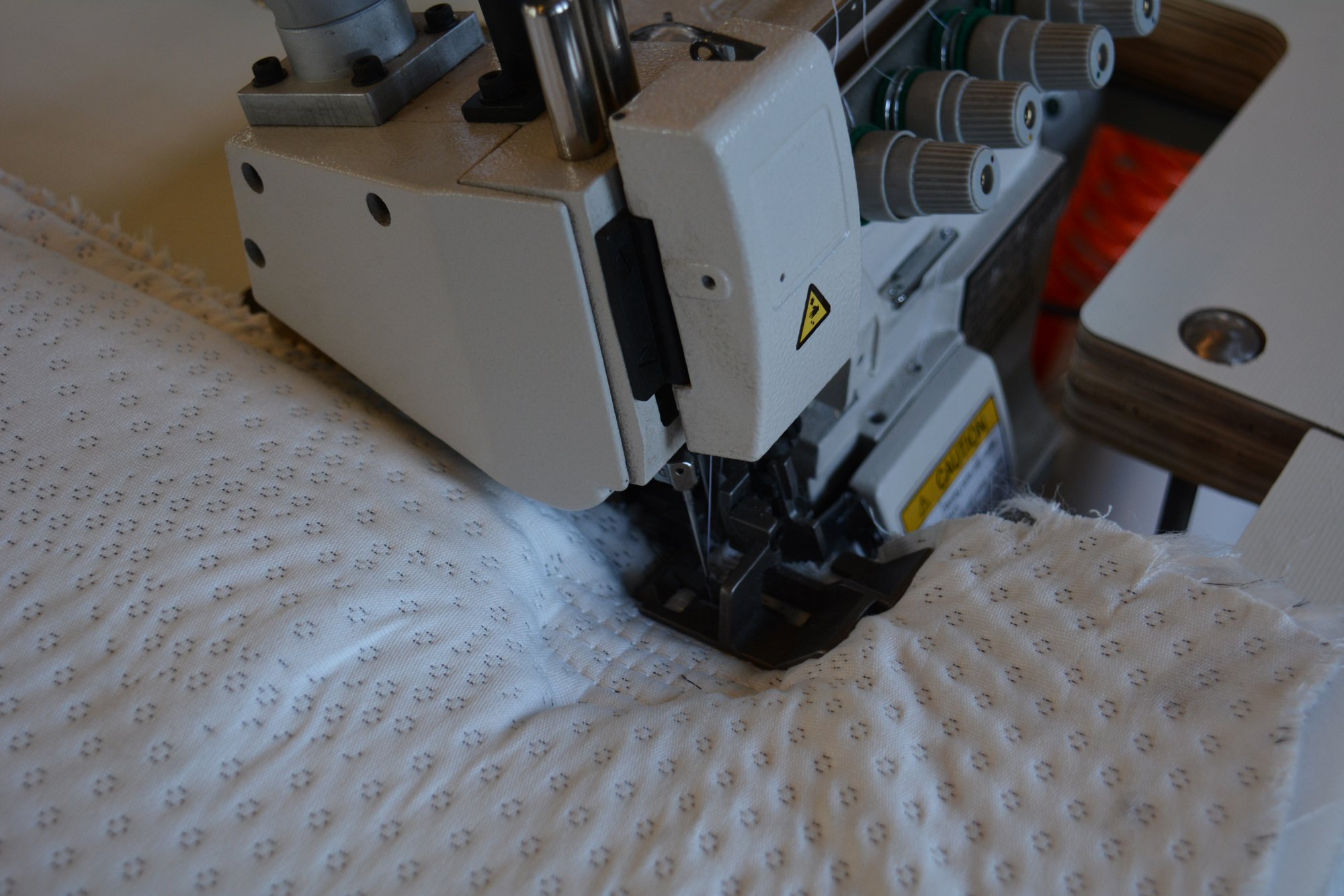 Square improves mattress flanging machine on heavy material feeding system